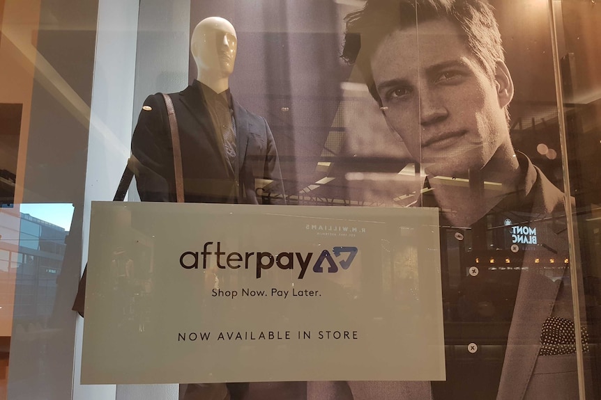 Fashion retailer window displaying 'Afterpay' sign