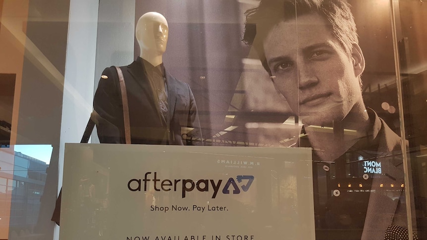 Fashion retailer window displaying 'Afterpay' sign