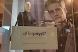 Fashion retailer window displaying 'Afterpay' sign