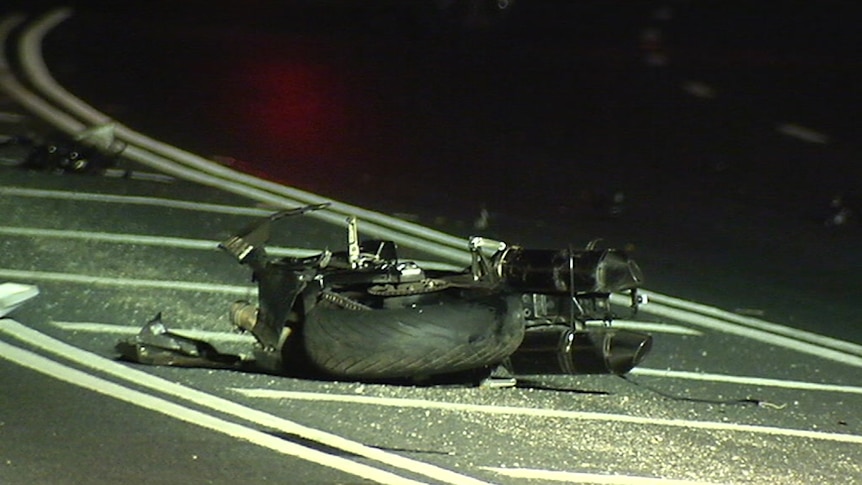 The wreckage of a motorbike on the road at the scene of the crash.