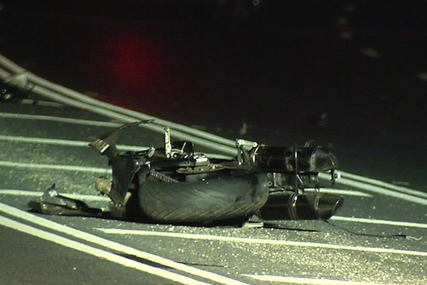 The wreckage of a motorbike on the road at the scene of the crash.