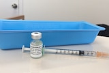 A bottle of vaccine and a needle