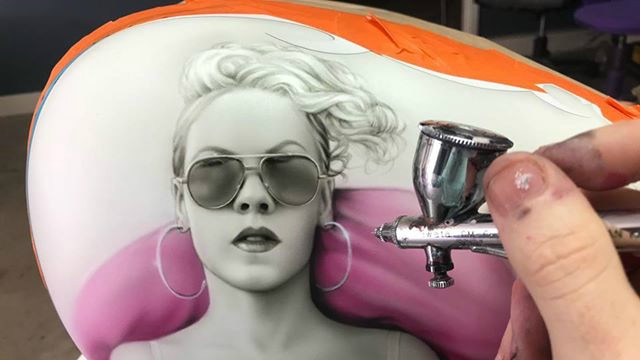 Airbrush painting of music artist Pink on a Harley tank