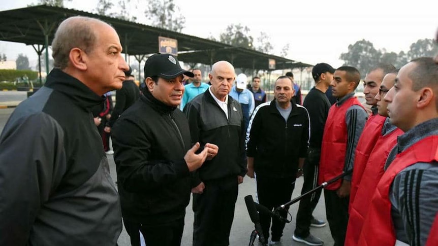 Egyptian President Abdel Fattah el Sissi speaks to military cadets in red vests