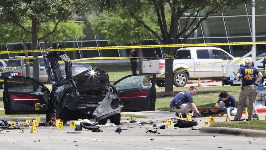 Local police and FBI investigators collect evidence where two gunmen were shot dead in Texas