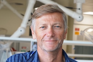 A man with blonde hair smiling at the camera. 