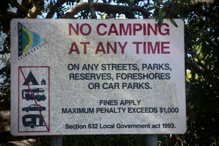 A sign warns that camping is not allowed.