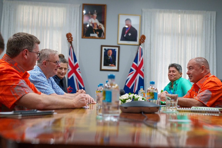 anthony albanese sits on one side of the table and pacific leaders sit on the other end