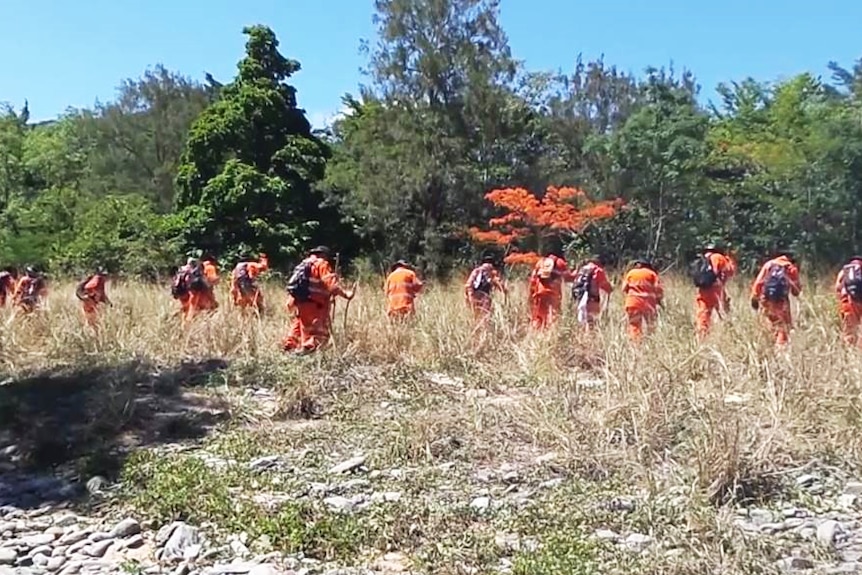 SES volunteers do a line search of an area near Lake Placid.