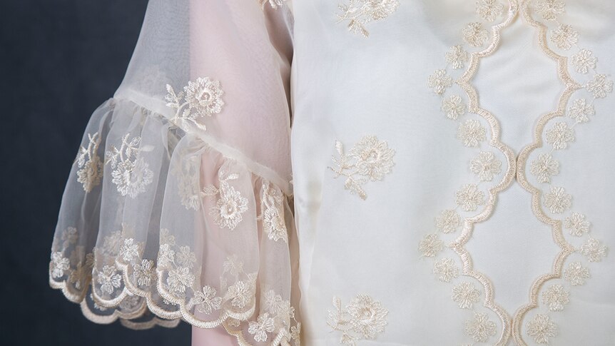 A close up image of embroidery on a ball gown