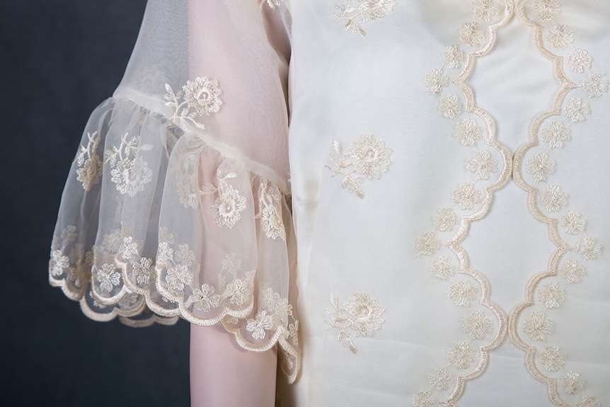 A close up image of embroidery on a ball gown