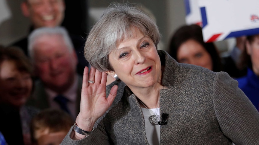 Britain's Prime Minister Theresa May listens to a voter at a campaign rally in Scotland