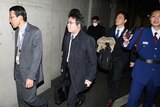Investigators enter the headquarter of Olympus in Tokyo on December 21, 2011.