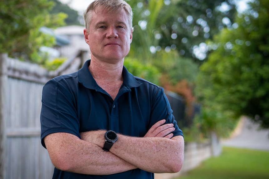 Cairns School of Distance Education teacher Geoff Wall standing with arms folded