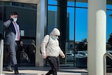 Psychologist Natasha Rosalie Hutchison leaving Maroochydore Court House hiding her face in mask and hoodie