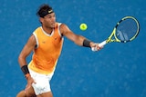 Spain's Rafael Nadal grimaces as he hits a forehand at the Australian Open.