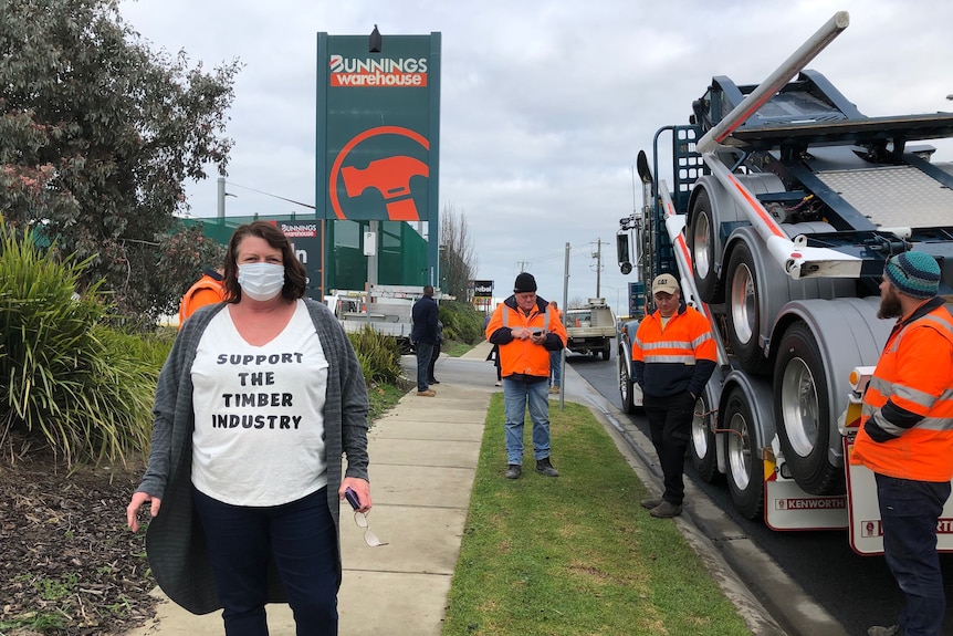 Felicia Stevenson from Heyfield wearing face mask and tshirt that reads 'support the timber industry' standing near Bunnings