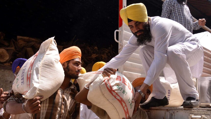 Indian volunteers load relief materials onto a truck to be taken to Nepal after the earthquake