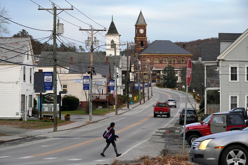 A woman crosses Main Street in Hinsdale, New Hampshire.