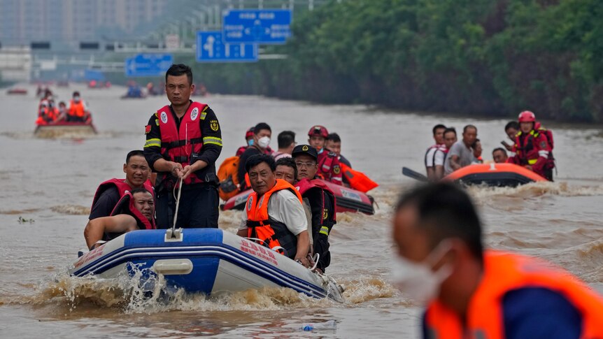 Residents evacuate on rubber boats through floodwaters in Zhuozhou in northern China's Hebei province.