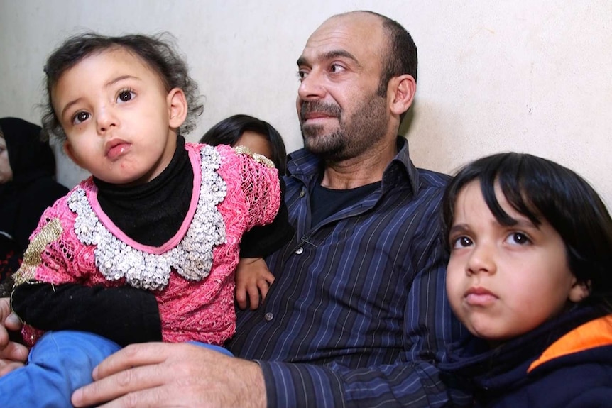 Syrian family looks sad reflecting on five years of war