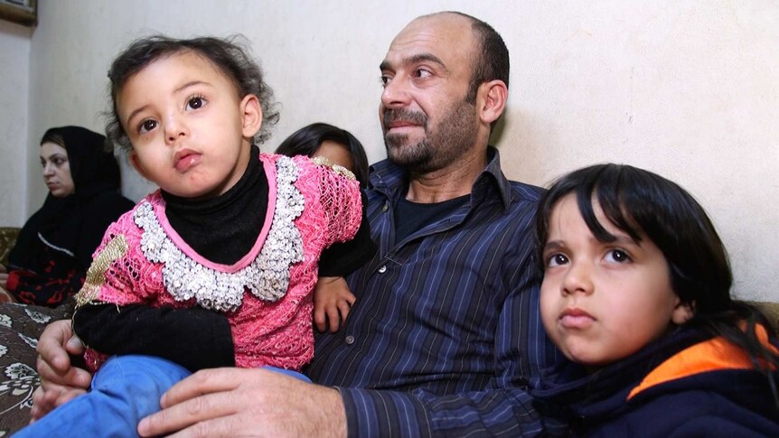 Syrian family looks sad reflecting on five years of war