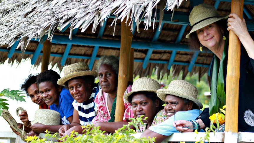 Rosie Boylan with Vanuatu women wearing woven pandanus leaf hats.