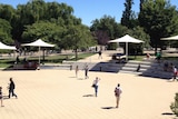 Students walk across a central paved area at ANU in Canberra.