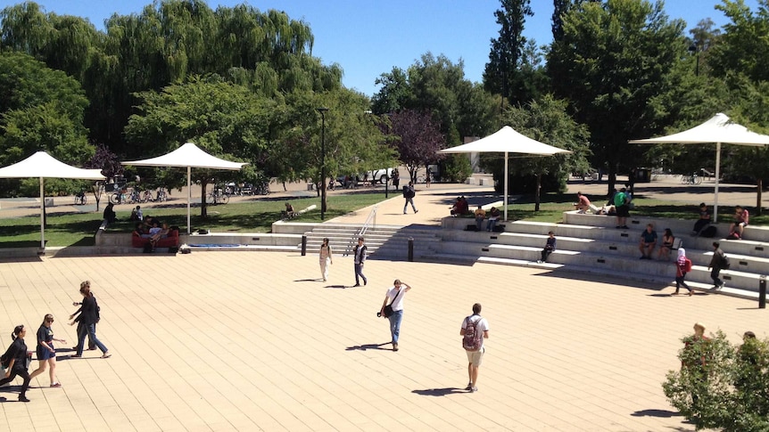 Students walk across a central paved area at ANU in Canberra.