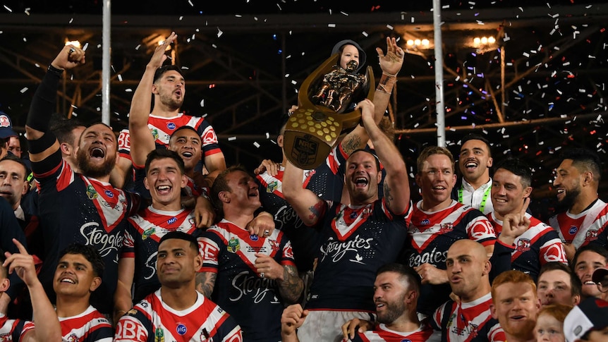 Roosters skipper Boyd Cordner lifts the NRL trophy