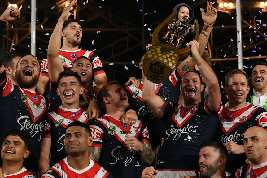 Roosters skipper Boyd Cordner lifts the NRL trophy