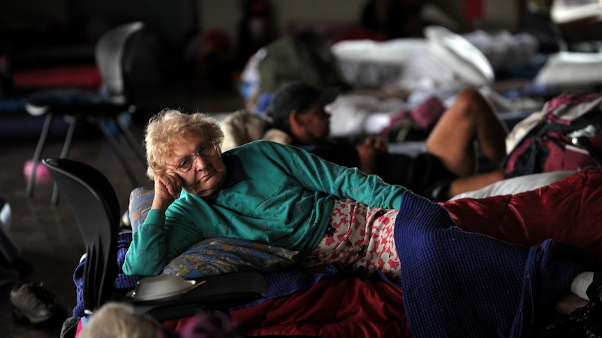 A resident of the flood-affected town of St George takes shelter in an evacuation centre in Dalby, Queensland.