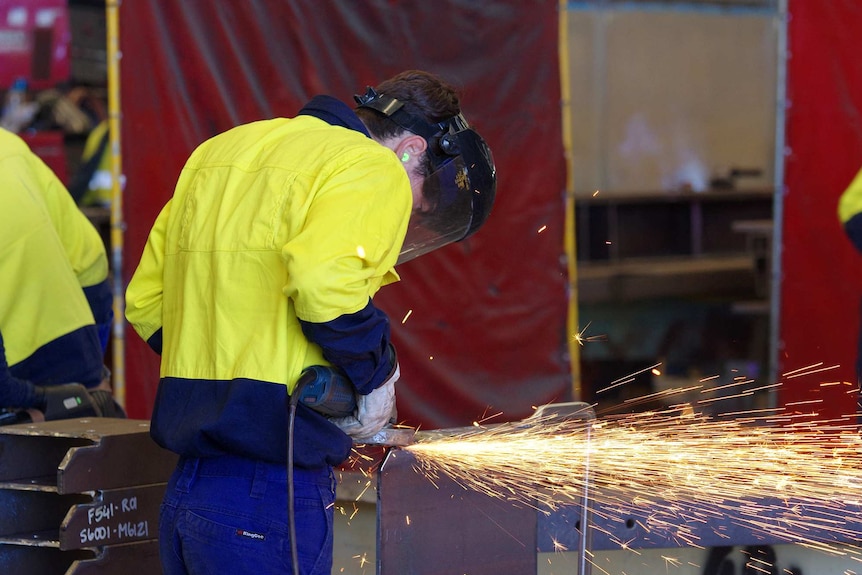 A manufacturing worker angle grinding steel at a ship building company in Perth. March 10, 2017.