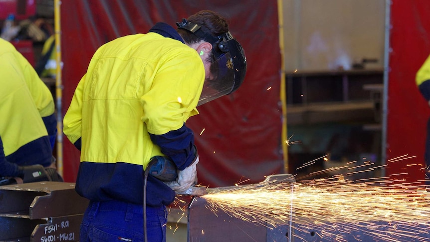 A manufacturing worker angle grinding steel at a ship building company in Perth. March 10, 2017.