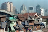 Office buildings dominate Indonesia's capital Jakarta in 1997, mixed with slums in foreground
