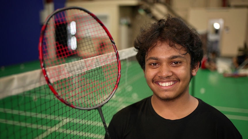 Rezwan Mohammed holding up his racquet.