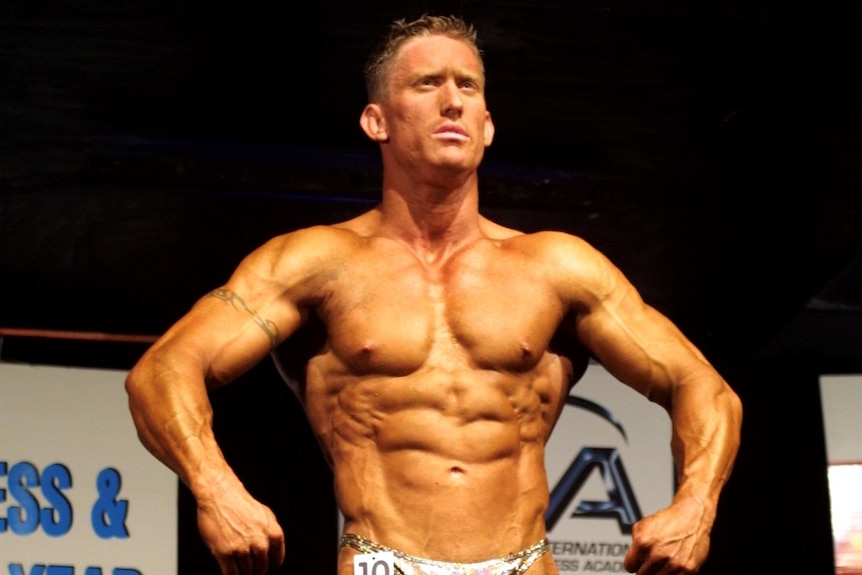 A male body builder posing on stage