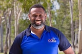 Portrait of man smiling with trees behind him