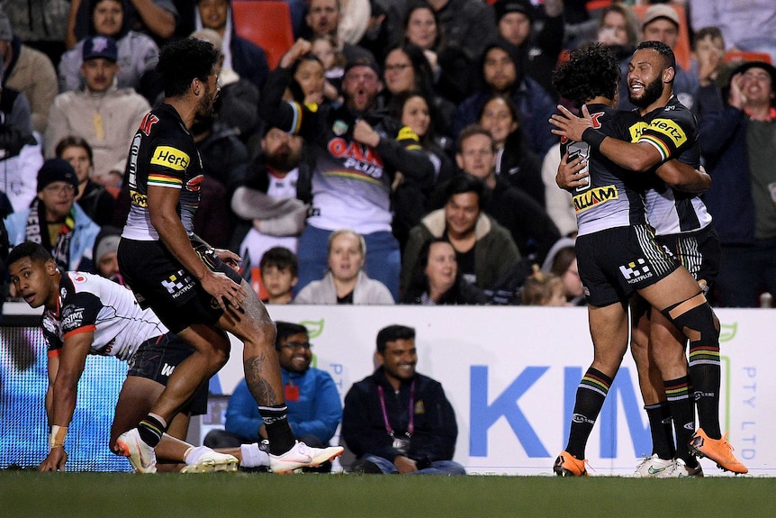 Tyrone Ranuku Phillips is congratulated after scoring a try for the Panthers against the Warriors.