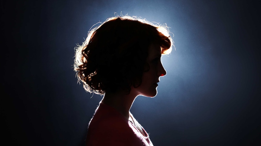 silhouette of a woman's face with light surrounding it