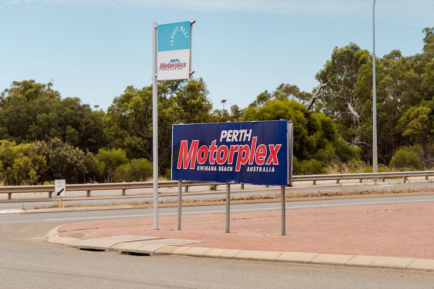 A sign that reads PERTH MOTORPLEX, Kwinana Beach Australia, on the side of a highway.