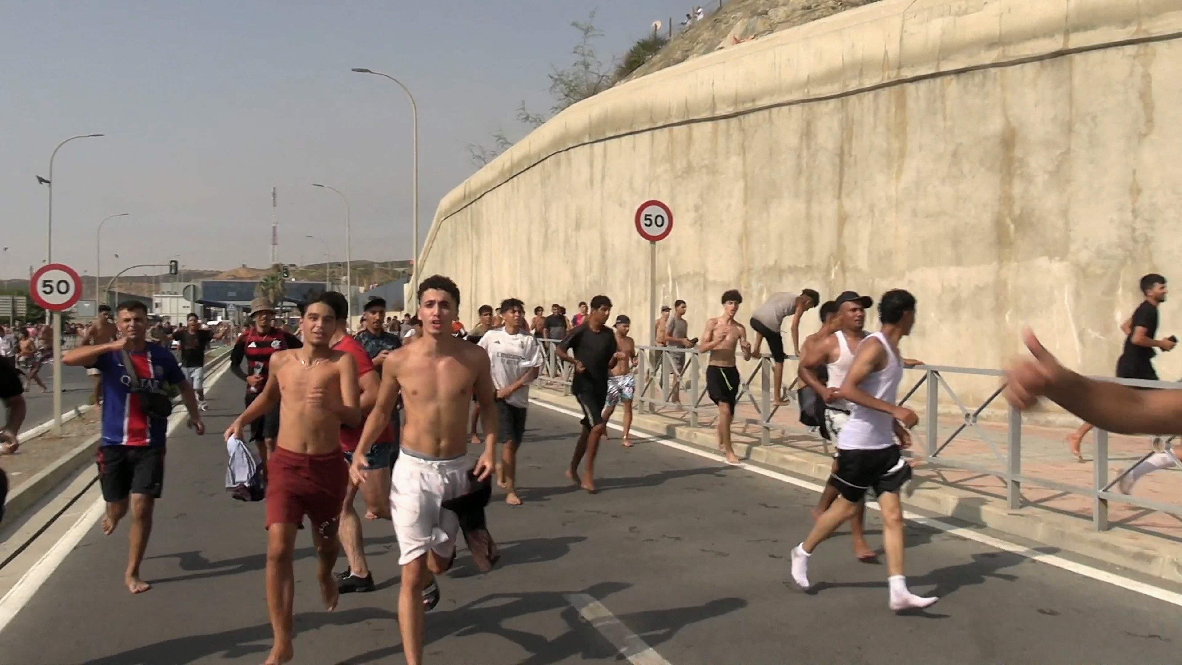 Migrants from Morocco pour into Spanish border territory