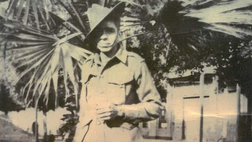 Douglas Love stands with a slouch hat and army uniform.