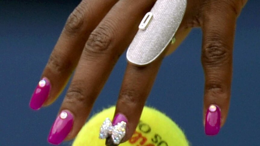 Venus Williams bounces the ball before serving.