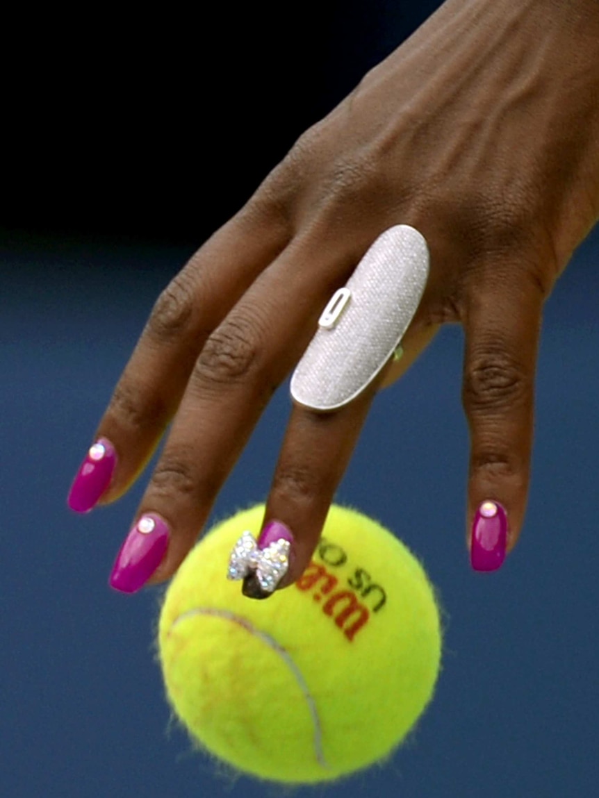 Venus Williams bounces the ball before serving.