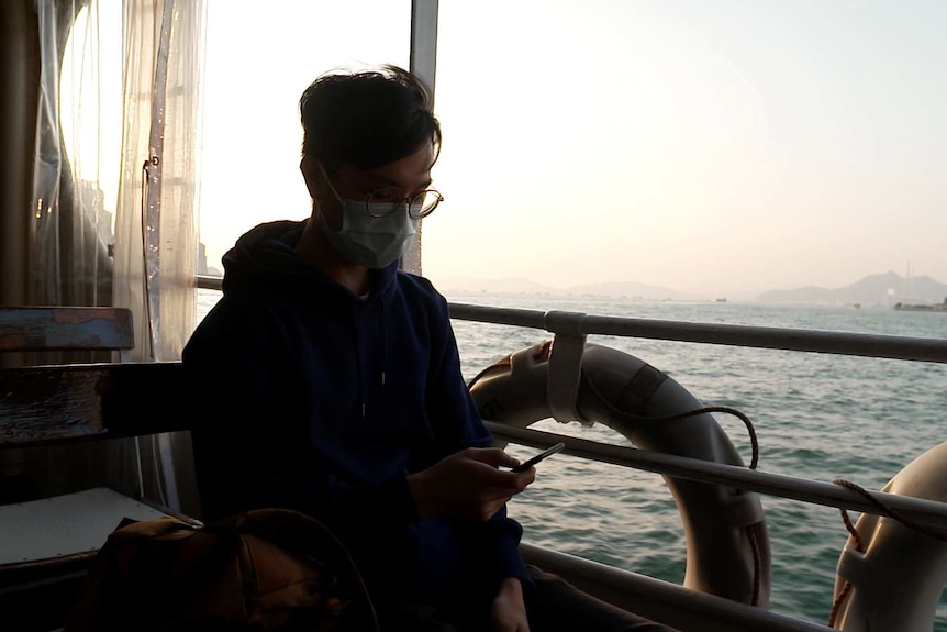 Max Mok catches the ferry on Hong Kong harbour.