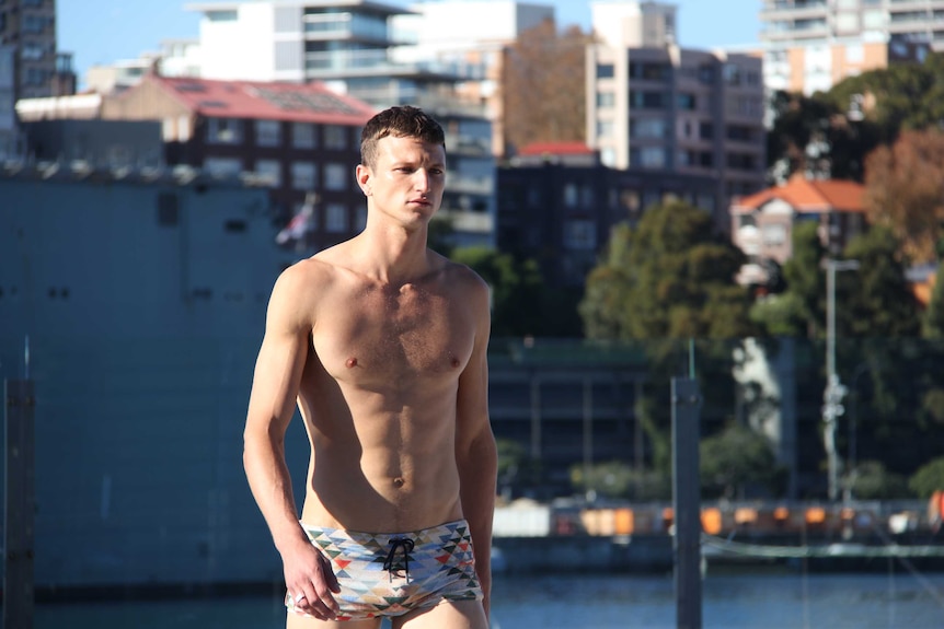 A male model walking an outdoor catwalk.