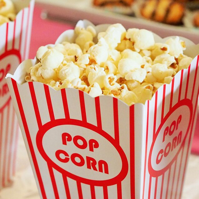 Red and white striped buckets of popcorn.