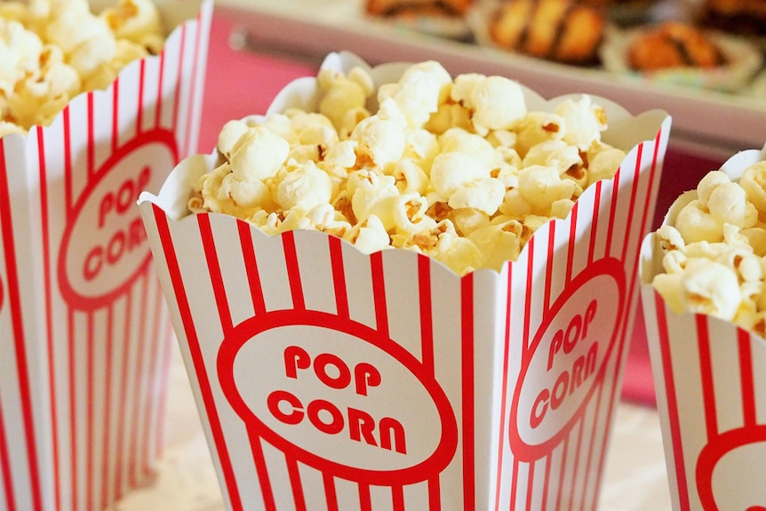 Red and white striped buckets of popcorn.