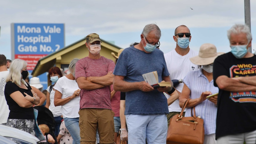 People line up with masks on at the Mona Vale Hospital